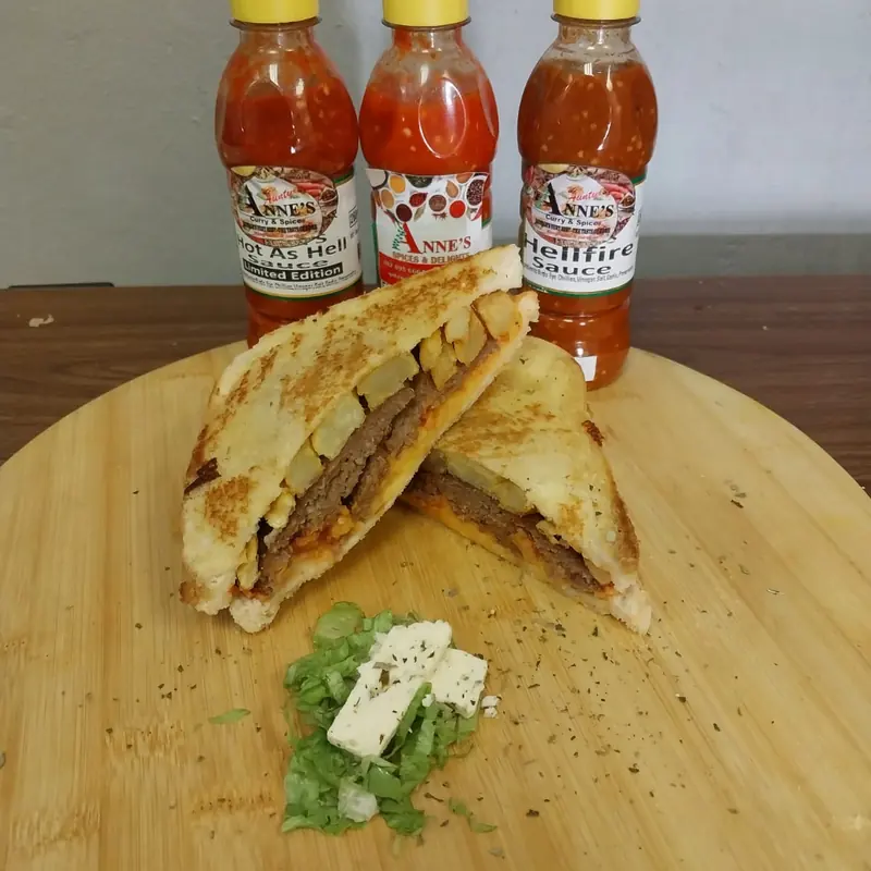 Chip, cheese and chilli toasted sandwich with the house Hellfire and Hot As Hell sauces